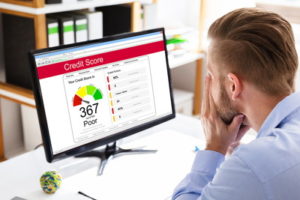 man looking at poor credit score rating online