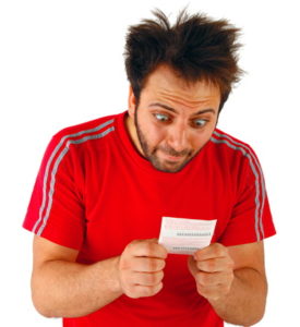 man looking at a bet slip with surprise