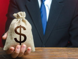 man handing money over in sack lobbying bribe