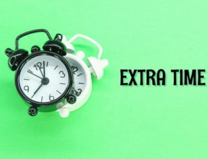 extra time written on green background with alarm clocks