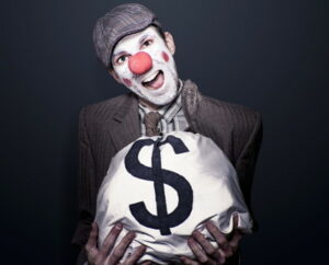 robber criminal dressed as a clown holding bag of cash